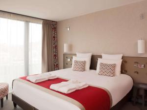 Postel nebo postele na pokoji v ubytování Mercure Clermont Ferrand centre Jaude