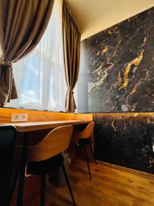 a table with two chairs next to a window at Boutique Hotel & Event Center in Budapest