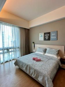 a bedroom with a large bed and a large window at TheEden#13 SwissGardenKL in Kuala Lumpur