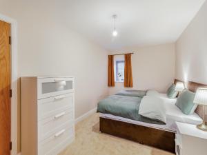 a small bedroom with a bed and a dresser at Robcross Barn in Airton