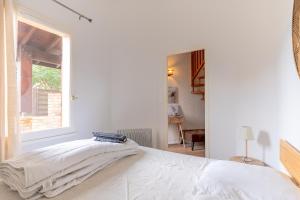 En eller flere senge i et værelse på Maisonnette Biscarosse