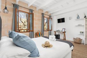a bedroom with a bed with a hat on it at Hotel Boutique Ses 5 Claus in Ciutadella