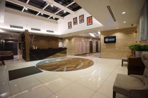 a large lobby with a reception desk in a building at Trinidad Suites Johor, Trademark Collection by Wyndham in Nusajaya