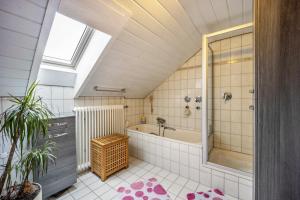 a bathroom with a shower and a bath tub at Elli in Aulendorf