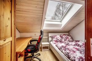 a small room with a bed and a desk and a chair at Elli in Aulendorf