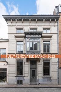 a white building with a sign that reads fully renovated at Dukes' Apartments Grand Place in Bruges