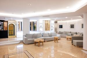 a large living room with couches and tables at Smy Santorini Suites & Villas in Pirgos