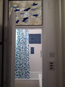 Un baño con una ventana con peces azules en Blue Danube Free publlic parking, en Novi Sad