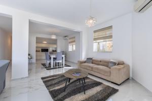 ein Wohnzimmer mit einem Sofa und einem Tisch in der Unterkunft Stunning - SunnySide 3-Bedroom in Sliema