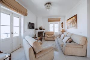 a living room with two couches and a tv at BC Beach House - Santa Cruz in Santa Cruz
