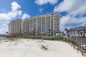 a large building on the beach next to the beach at Beach Club 708D in Gulf Shores