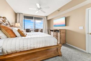 a bedroom with a bed and a window at Beach Club 708D in Gulf Shores