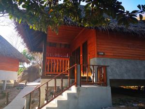 a house with a staircase leading to the door at Koh Tao Relax Freedom Beach Resort in Koh Tao