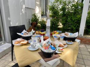 a table with food on it with a dog behind it at Frontemare Hotel Village & Ristorante in Rodi Garganico