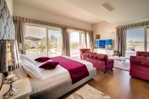 a bedroom with a large bed and a large window at Wine Residence Cattunar in Brtonigla