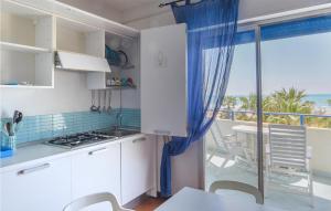 a kitchen with a view of the ocean at Gorgeous Apartment In Pozzallo in Pozzallo