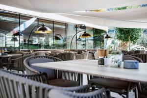 an empty restaurant with tables and chairs at Hotel Arlmont 4 Stern Superior in Sankt Anton am Arlberg