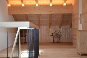 a room with a staircase and a wooden ceiling at Ferienhaus Rimsgrund in Bezau