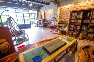 a large room with a table in the middle of a library at Fun Shili B&B in Shuili