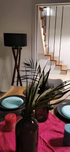 a dining room table with two plates and a plant at Elegant Seaside 2 Floor Apartment in Athens