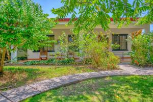 a house with a garden in front of it at Casa Iorio in Jacó