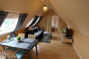 a living room with a couch and a table at Wunderschön zwischen Ortsausgang und Waldesrand gelegene, schöne Apartments in Herzogenrath
