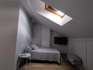 Łóżko lub łóżka w pokoju w obiekcie Pensión Residencial Platas