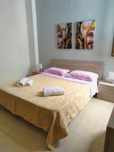 a bedroom with a large bed with two pillows at My Home Lampedusa in Lampedusa