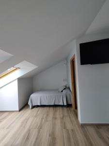 Łóżko lub łóżka w pokoju w obiekcie Pensión Residencial Platas