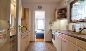 a kitchen with a sink and a window in it at Ferienwohnung Golfblick in Wittenbeck