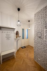 a room with two pendant lights and a brick wall at Turquoise inspired deluxe centrally located in Vienna