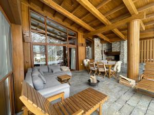 a living room with a couch and a table at Pirin Golf and Spa Luxury Chalet in Bansko