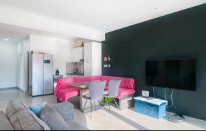 a living room with a pink couch and a table at Apartment AS MOON with swimming pool in Split