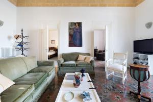 a living room with a couch and a table at Il Giardino Ritrovato in Marsala