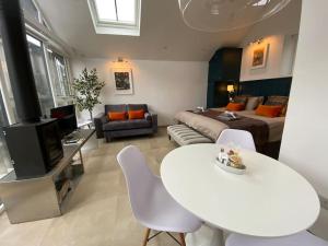 a living room with a white table and a couch at Tiny home, the Wye Valley, Clanna Cottage Llandogo in Llandogo