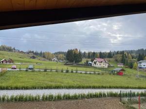 a view of a farm from a window at Chalet Poligon in Vatra Dornei