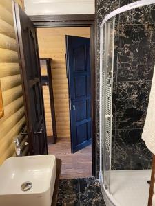 a bathroom with a tub and a sink and a shower at Chalet Poligon in Vatra Dornei