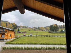 a view of a farm from the window of a cabin at Chalet Poligon in Vatra Dornei