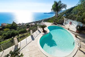 a swimming pool with a view of the ocean at Villa Luce in Letojanni