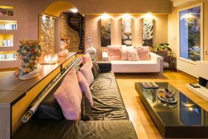 a large living room with a couch and a bed at Villa Luce in Letojanni