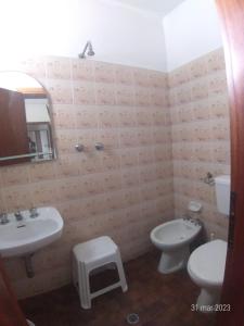 a bathroom with two sinks and a toilet and a mirror at Hotel Rosy in Bellaria-Igea Marina