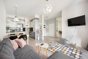 a living room with a couch and a table at Ursynów Geometric Homey Apartment in Warsaw