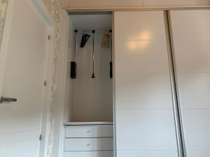 a closet with white cabinets and a glass door at Casa Rural en Santa Cruz-Mieres in Bustiello +91 photos
