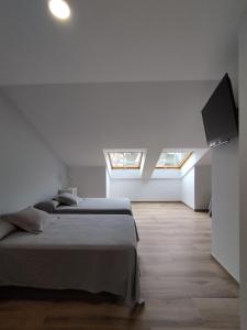 Łóżko lub łóżka w pokoju w obiekcie Pensión Residencial Platas