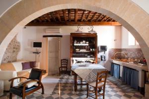 a kitchen and living room with a table and chairs at Baglio Maranzano - Titi in Buseto Palizzolo +35 photos
