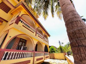 a building with a palm tree in front of it at Sea View Resorts in Bogmolo