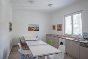 a kitchen with a table and chairs and a sink at Stone House Buljanovic in Sali