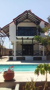 a house with a swimming pool in front of it at Cabaña Recinto del Pensar in Santa Marta
