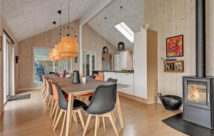 a kitchen and dining room with a table and a fireplace at Gorgeous Home In Glesborg With Sauna in Glesborg
