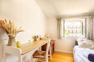 sypialnia z biurkiem, łóżkiem i oknem w obiekcie 6 - Charming studio,Heart old town, beach walk w mieście Antibes